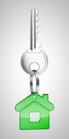 green key chain with key in form of homeの写真素材
