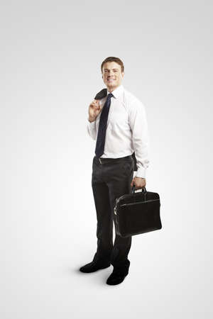 smiling businessman with a suitcase in handの写真素材