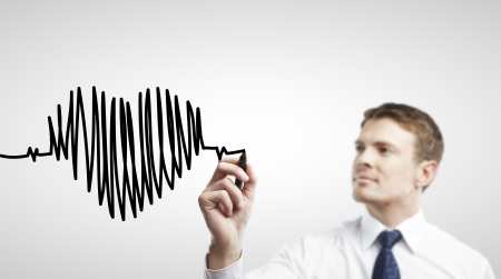 businessman drawing chart heartbeat on a white backgroundの写真素材