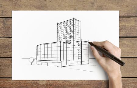 Hand drawing  skyscraper  on  piece of paperの写真素材