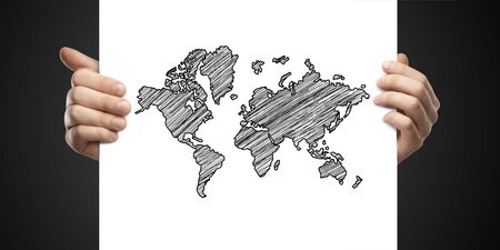 man holding card with drawing map on a black background
