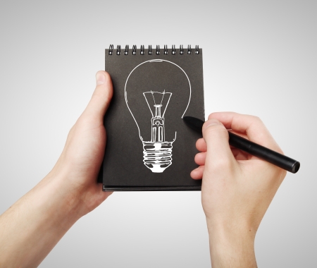 hand drawing lamp in black notepadの写真素材