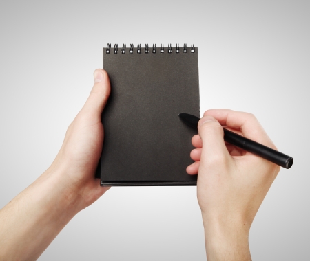 black notepad and pencil in handの写真素材