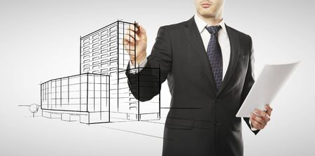 young businessman drawing house projectの写真素材