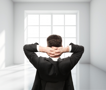 businessman sitting in chair in white roomの写真素材