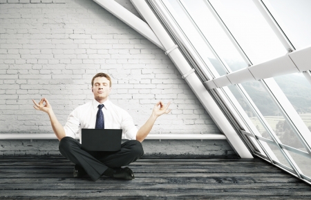 businessman meditation in brick roomの写真素材