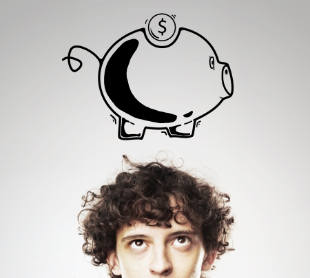 boy dreaming about piggy bankの写真素材