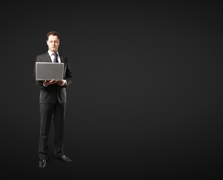 man with laptop on black backgroundの写真素材