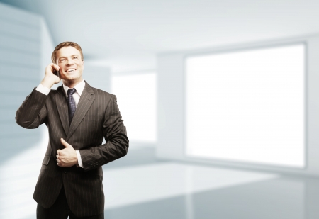 businessman with phone  in white roomの写真素材
