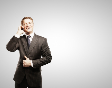 businessman with phone on gray backgroundの写真素材