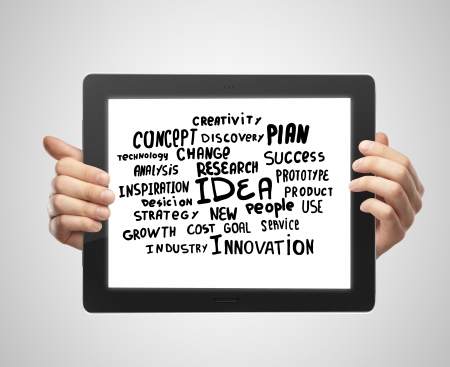 hands holding tablet with business tagsの写真素材