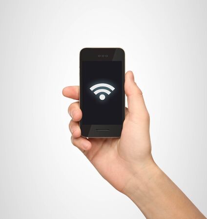 Hand holding mobile smart phone with connection symbolの写真素材