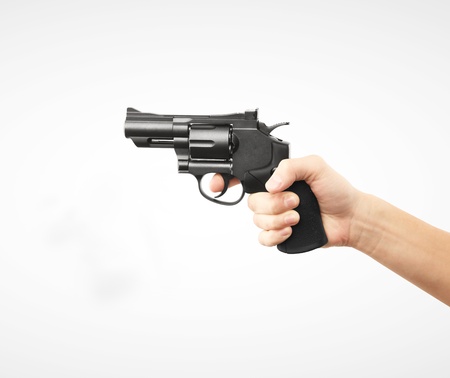 revolver in  hand on a white backgroundの写真素材