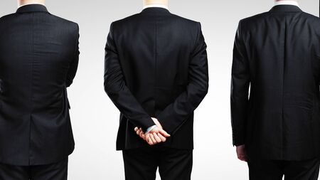 three businessmen in suit's stending back