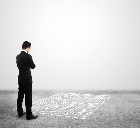 man looking at labyrinth on a white backgroundの写真素材