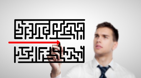 businessman drawing labyrinth on a white backgroundの写真素材