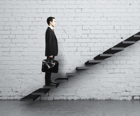 man stepping up a staircaseの写真素材