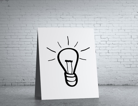 table with lamp symbol and brick wallの写真素材