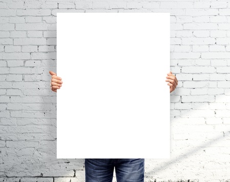 businessman holding white blank posterの写真素材