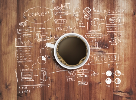 coffee cup and business strategy on wooden tableの写真素材
