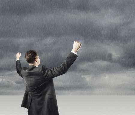 happy young businessman and thunderstormの写真素材