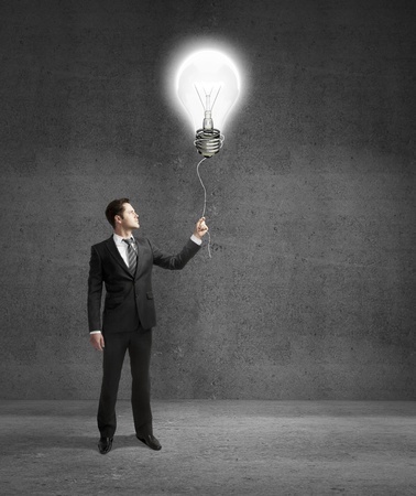 businessman standing on concrete room with drawing lampの写真素材