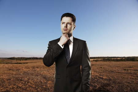 businessman thinking on a nature backgroundの写真素材