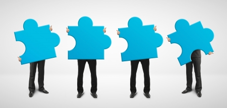 four man holding blue puzzle cardの写真素材