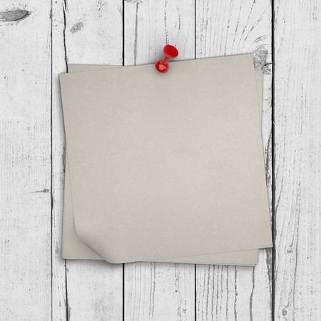 note paper pinned on white wooden wall