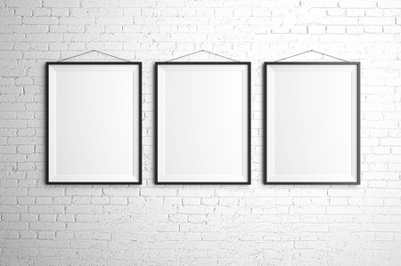 three black frames on brick wallの写真素材