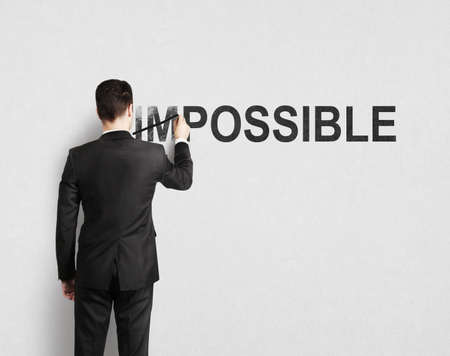 man drawing impossible on wallの写真素材