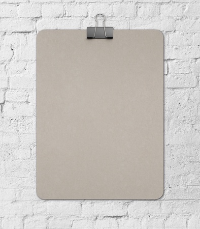 blank clipboard on a brick wall backgroundの写真素材