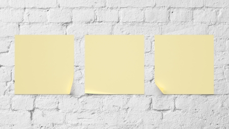 three yellow sticker on brick wallの写真素材