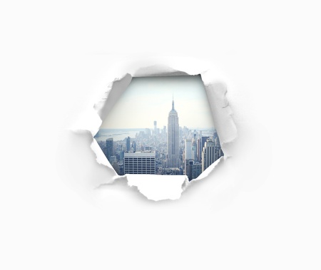 Hole in paper and modern cityの写真素材