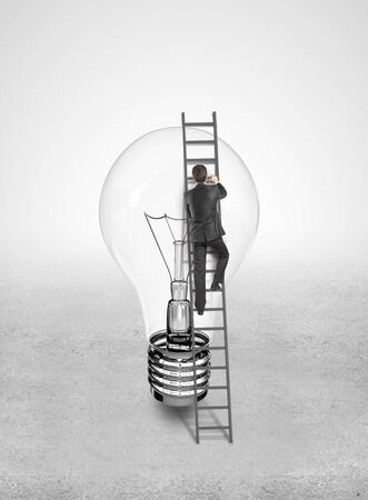 businessman rise on light bulbの写真素材
