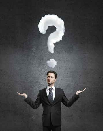 businessman with question mark and concrete wallの写真素材