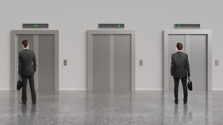 two businessman and elevator with closed doors