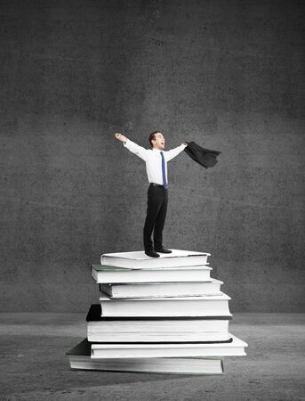happines businnesman standing on booksの写真素材