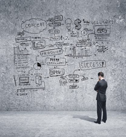 man looking strategy on concrete wallの写真素材