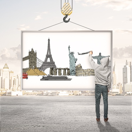 boy drawing on blank billboard traveling conceptの写真素材