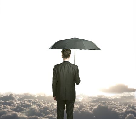 businessman with umbrella standing on a cloudの写真素材