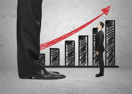 big and small businessman and a schedule on wallの写真素材