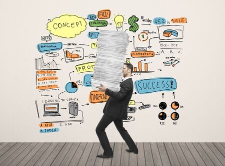 businessman holding paper and business plan drawing on wallの写真素材