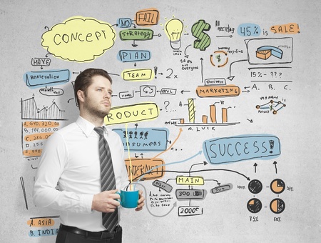 man with cup of coffe and drawing business planの写真素材