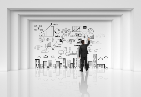 businessman dgawing at drawing business strategy on wallの写真素材