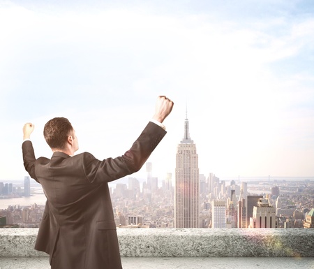 happiness businessman on roof skyscraperの写真素材