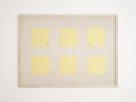 cork bulletin board with yellow notesの写真素材