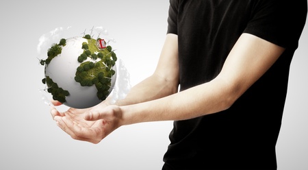 hands holding earth on gray background