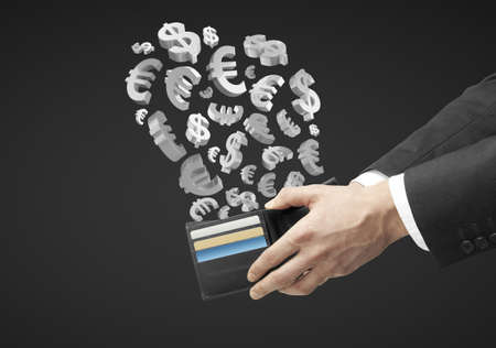 hands holding purse with flying silver dollars and eurosの写真素材