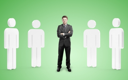 businessman among 3d people on green backgroundの写真素材